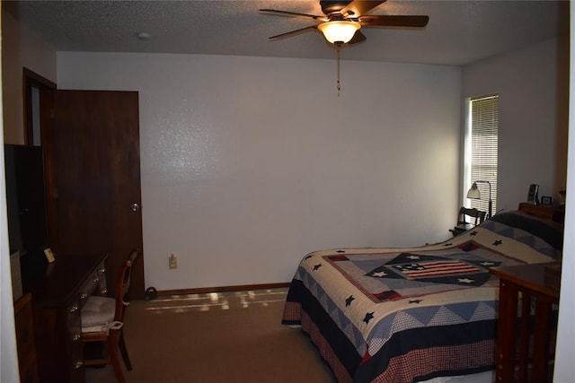 bedroom featuring carpet, a textured ceiling, and ceiling fan