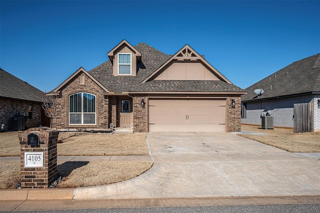 view of front of house featuring a garage and central air condition unit