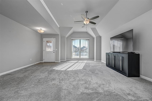 unfurnished living room featuring ceiling fan, carpet floors, and lofted ceiling