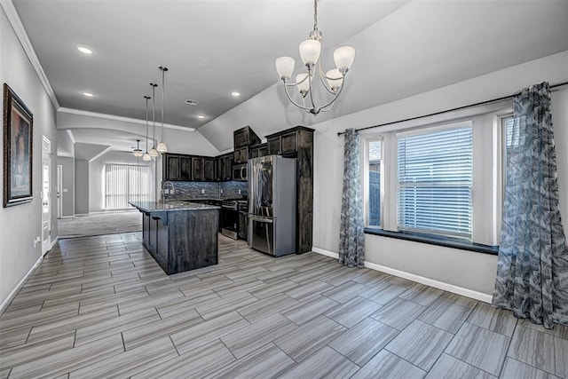 kitchen with a center island, sink, an inviting chandelier, hanging light fixtures, and appliances with stainless steel finishes