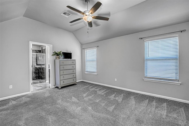 unfurnished bedroom with ensuite bath, ceiling fan, vaulted ceiling, and carpet floors