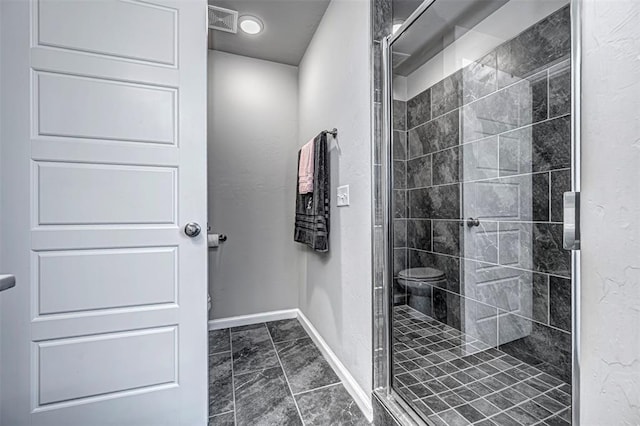 bathroom with a shower with door