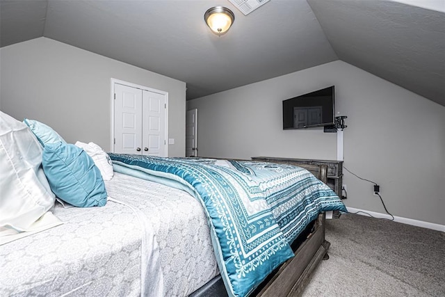 carpeted bedroom with vaulted ceiling and a closet