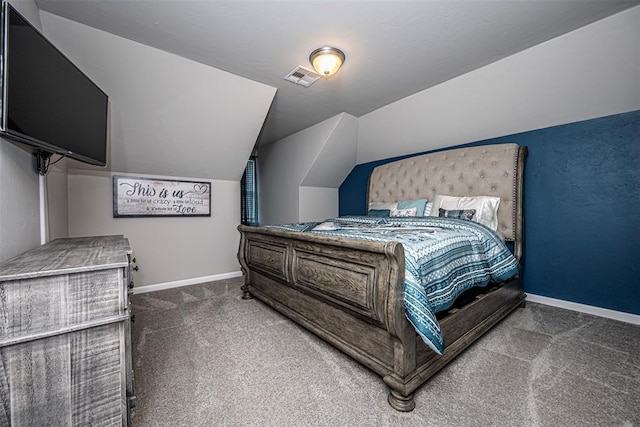 bedroom with vaulted ceiling and dark carpet