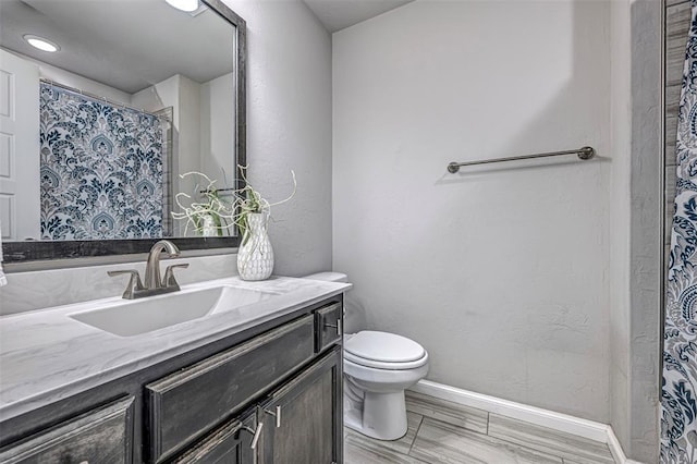 bathroom featuring toilet and vanity