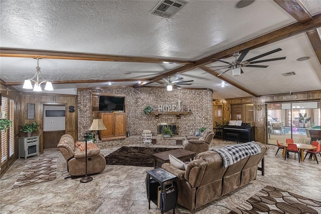 living room with lofted ceiling with beams, a textured ceiling, a brick fireplace, ceiling fan with notable chandelier, and wood walls