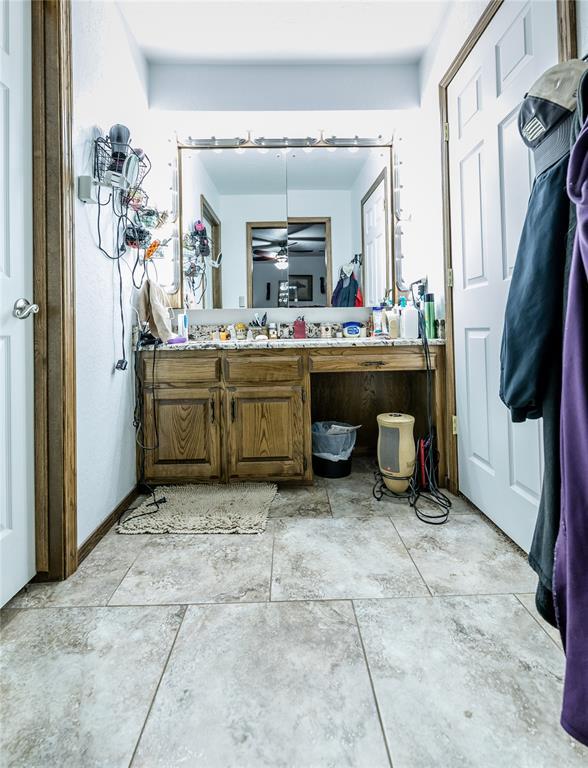 bathroom featuring vanity, a workshop area, and ceiling fan