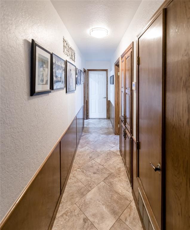 hallway featuring a textured ceiling