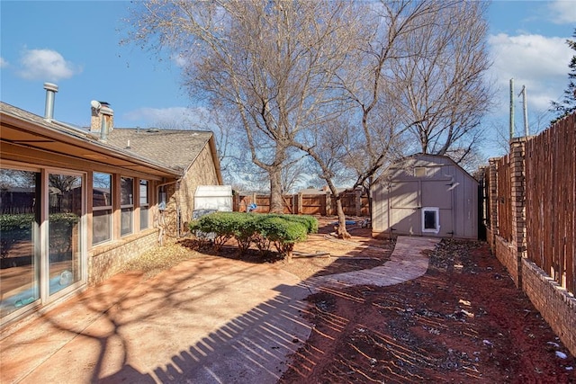 view of yard featuring a patio and a storage shed