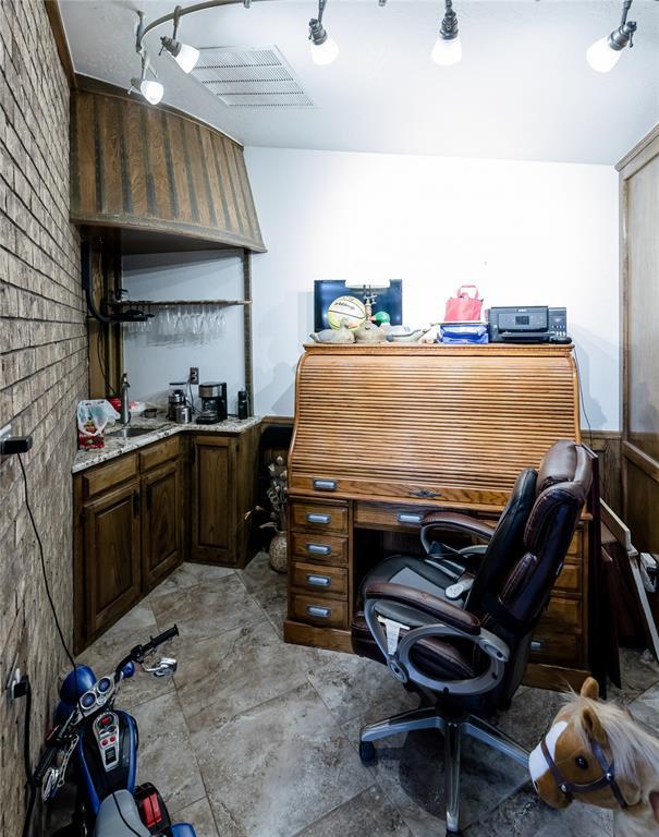 office area with brick wall and wooden walls