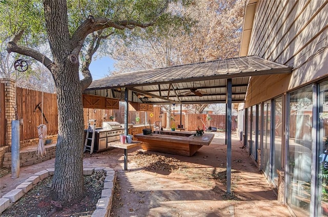 view of patio with area for grilling and ceiling fan