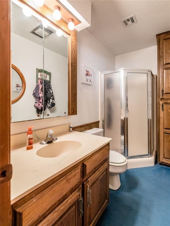 bathroom featuring vanity, toilet, and walk in shower