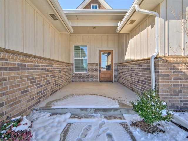 view of snow covered property entrance