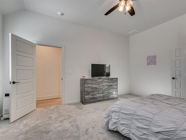 carpeted bedroom with ceiling fan and lofted ceiling