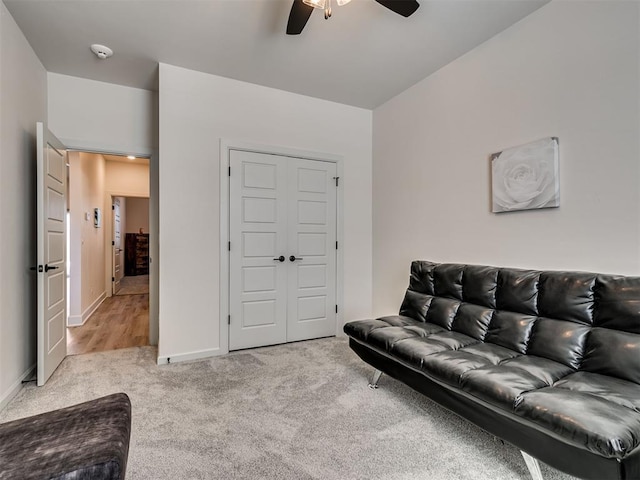 carpeted living room featuring ceiling fan