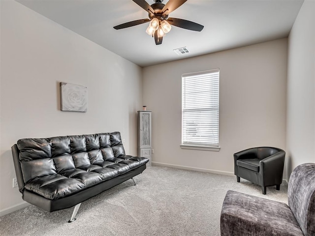 living room featuring light carpet and ceiling fan