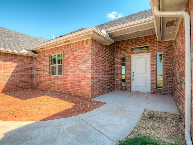 entrance to property featuring a patio