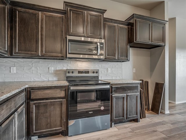 kitchen featuring dark brown cabinetry, stainless steel appliances, and light hardwood / wood-style floors