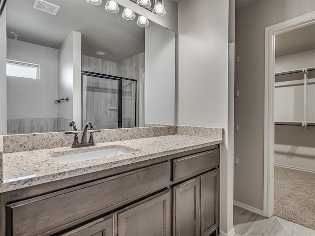 bathroom featuring vanity and walk in shower