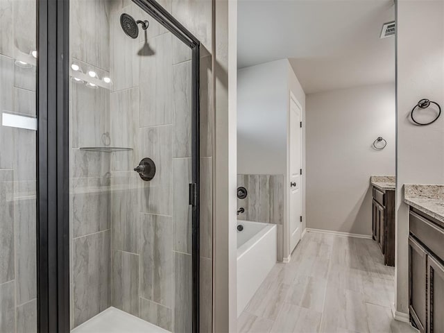 bathroom with separate shower and tub and vanity