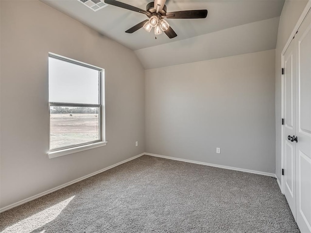 unfurnished room featuring ceiling fan, carpet, and vaulted ceiling