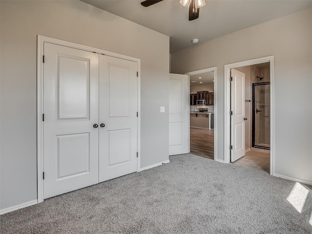 unfurnished bedroom with ceiling fan, light colored carpet, and a closet