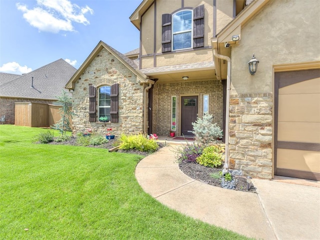 entrance to property with a lawn