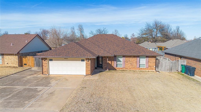 ranch-style home featuring a front lawn and a garage