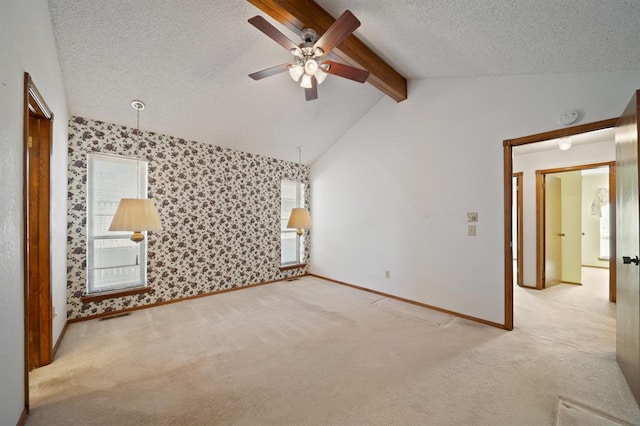 interior space featuring a textured ceiling, vaulted ceiling with beams, light carpet, and ceiling fan