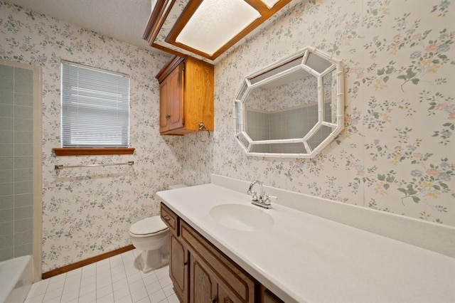 bathroom featuring a bathtub, tile patterned flooring, vanity, and toilet