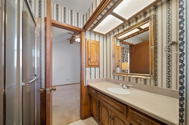 bathroom featuring tile patterned flooring, a textured ceiling, ceiling fan, and vanity