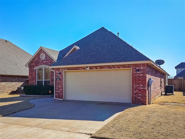 view of front of house featuring a garage and central AC unit