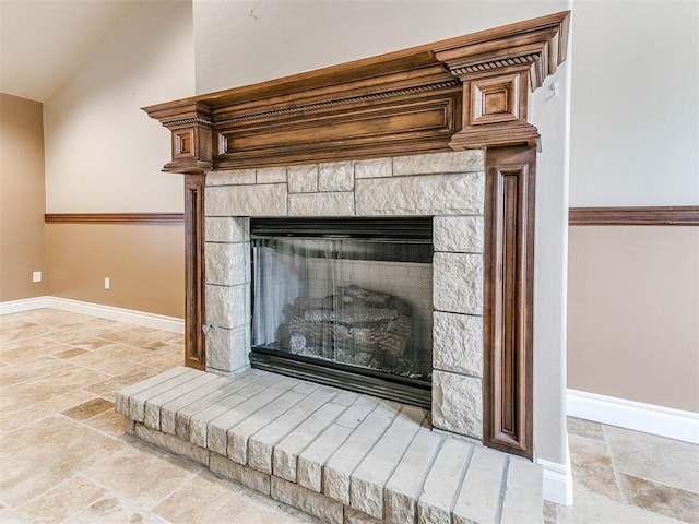 interior details with a stone fireplace