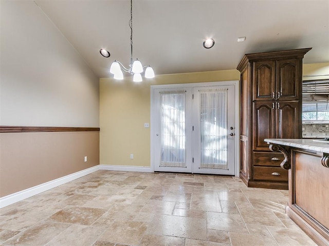 unfurnished dining area with an inviting chandelier