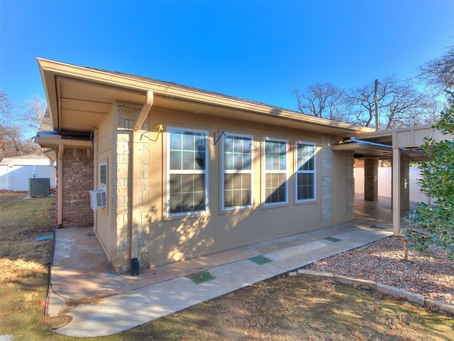 view of side of property featuring central AC