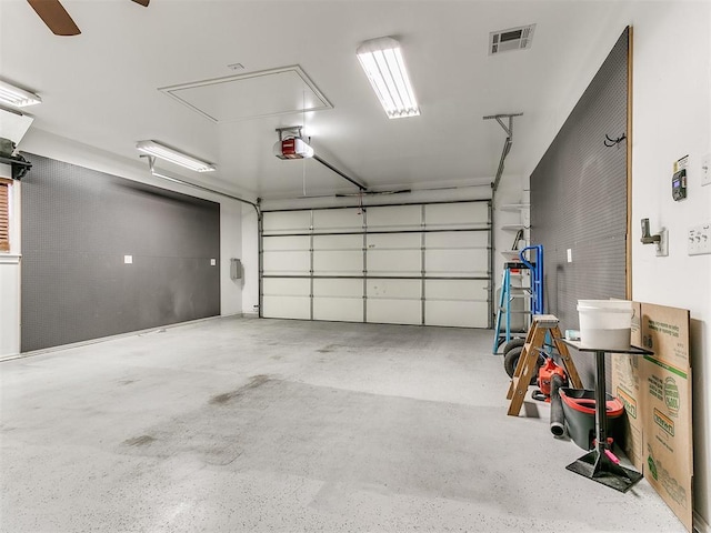 garage with ceiling fan and a garage door opener