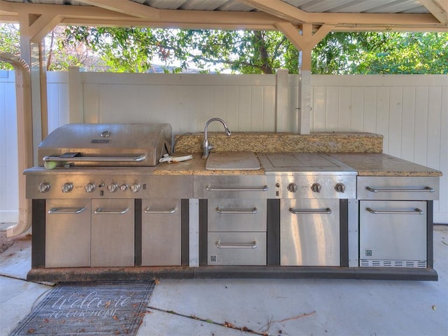 view of patio featuring exterior kitchen