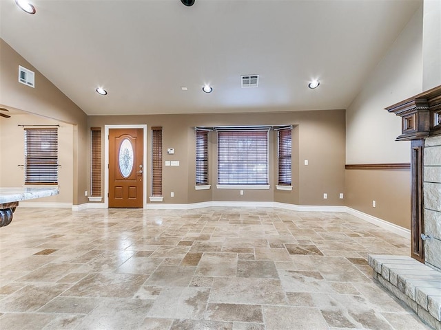 6704 Tall Oaks Dr, Oklahoma City, OK 73127 - foyer entrance featuring stone tile flooring, vaulted ceiling, healthy amount of natural light, baseboards, and recessed lighting