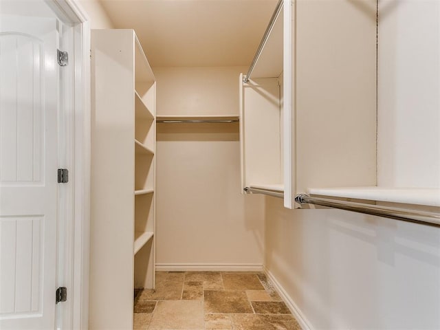 6704 Tall Oaks Dr, Oklahoma City, OK 73127 - spacious closet featuring light stone finish floors