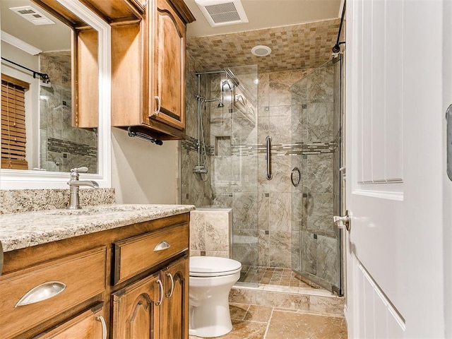 6704 Tall Oaks Dr, Oklahoma City, OK 73127 - bathroom with a shower stall, toilet, vanity, stone tile floors, and ornamental molding