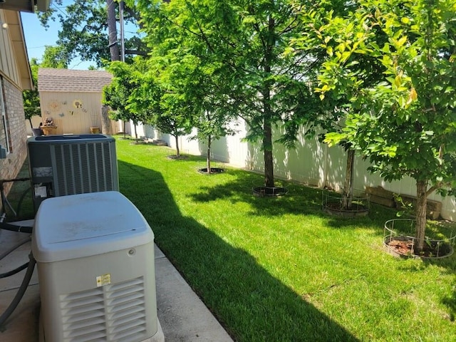 6704 Tall Oaks Dr, Oklahoma City, OK 73127 - view of yard featuring central AC unit, an outdoor structure, and a storage shed