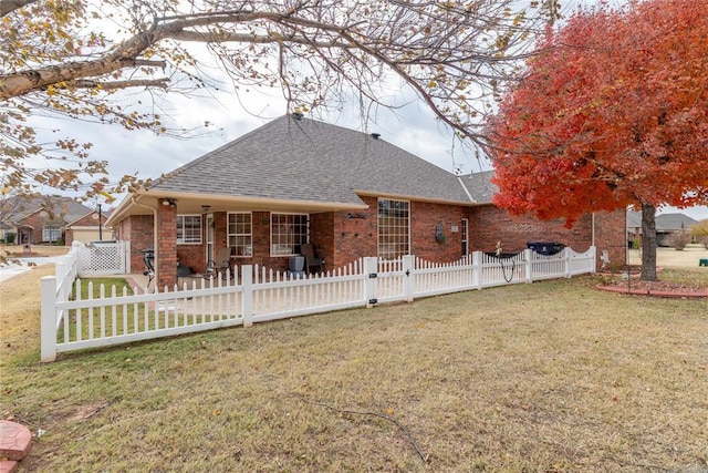 rear view of house featuring a lawn