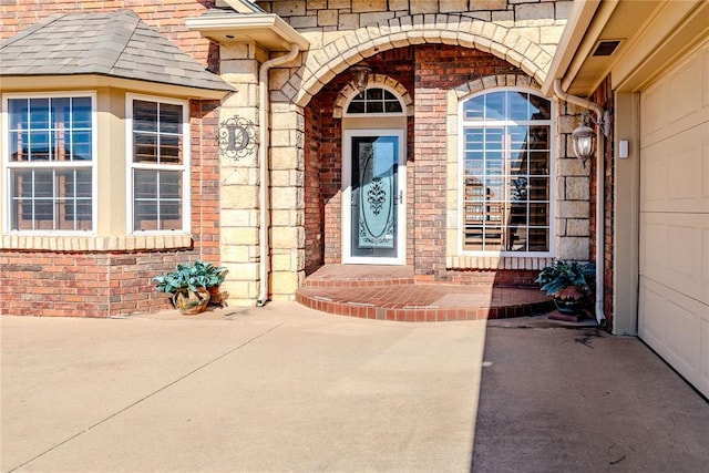 view of exterior entry with a patio area