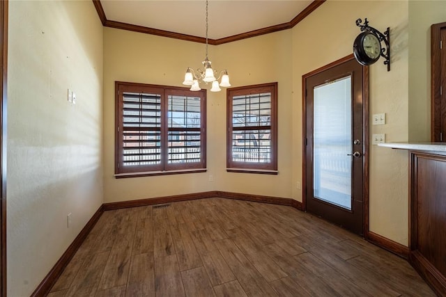 unfurnished dining area featuring an inviting chandelier, dark wood-type flooring, and ornamental molding