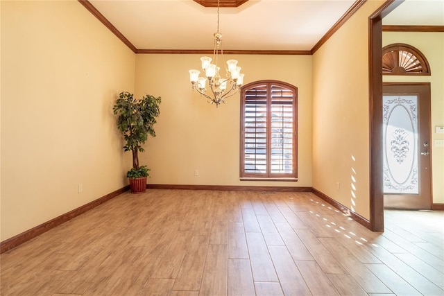 foyer entrance with an inviting chandelier, ornamental molding, and light hardwood / wood-style floors