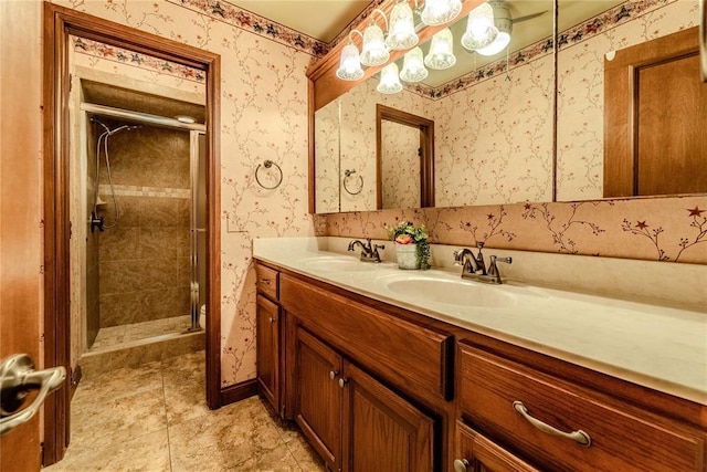 bathroom with a shower with door and vanity