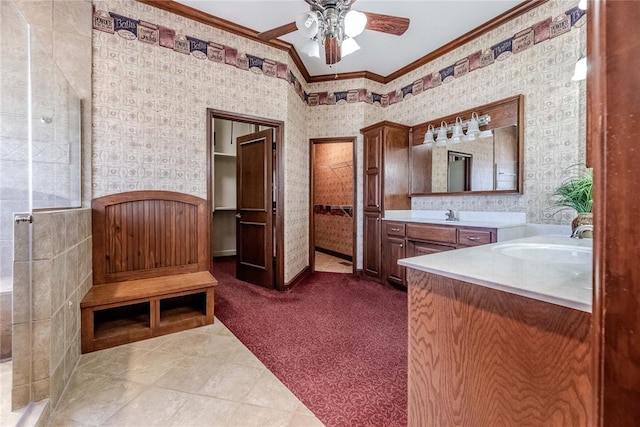 bathroom featuring ceiling fan, ornamental molding, vaulted ceiling, and vanity