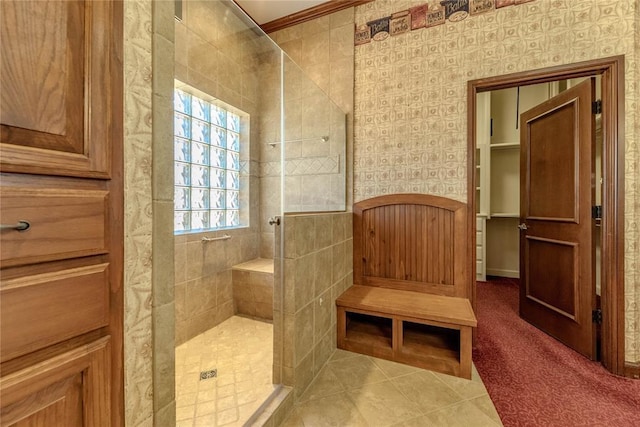 bathroom featuring a tile shower and tile patterned floors