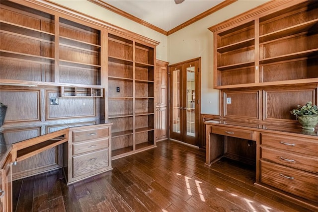 unfurnished office featuring crown molding, dark hardwood / wood-style flooring, and built in desk