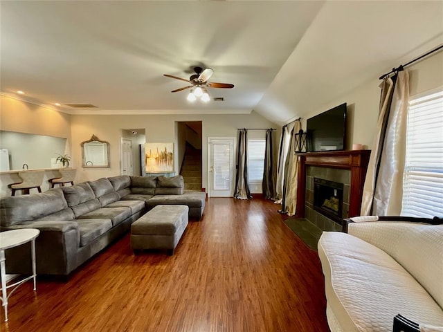 living room with ceiling fan, dark hardwood / wood-style flooring, a wealth of natural light, and vaulted ceiling